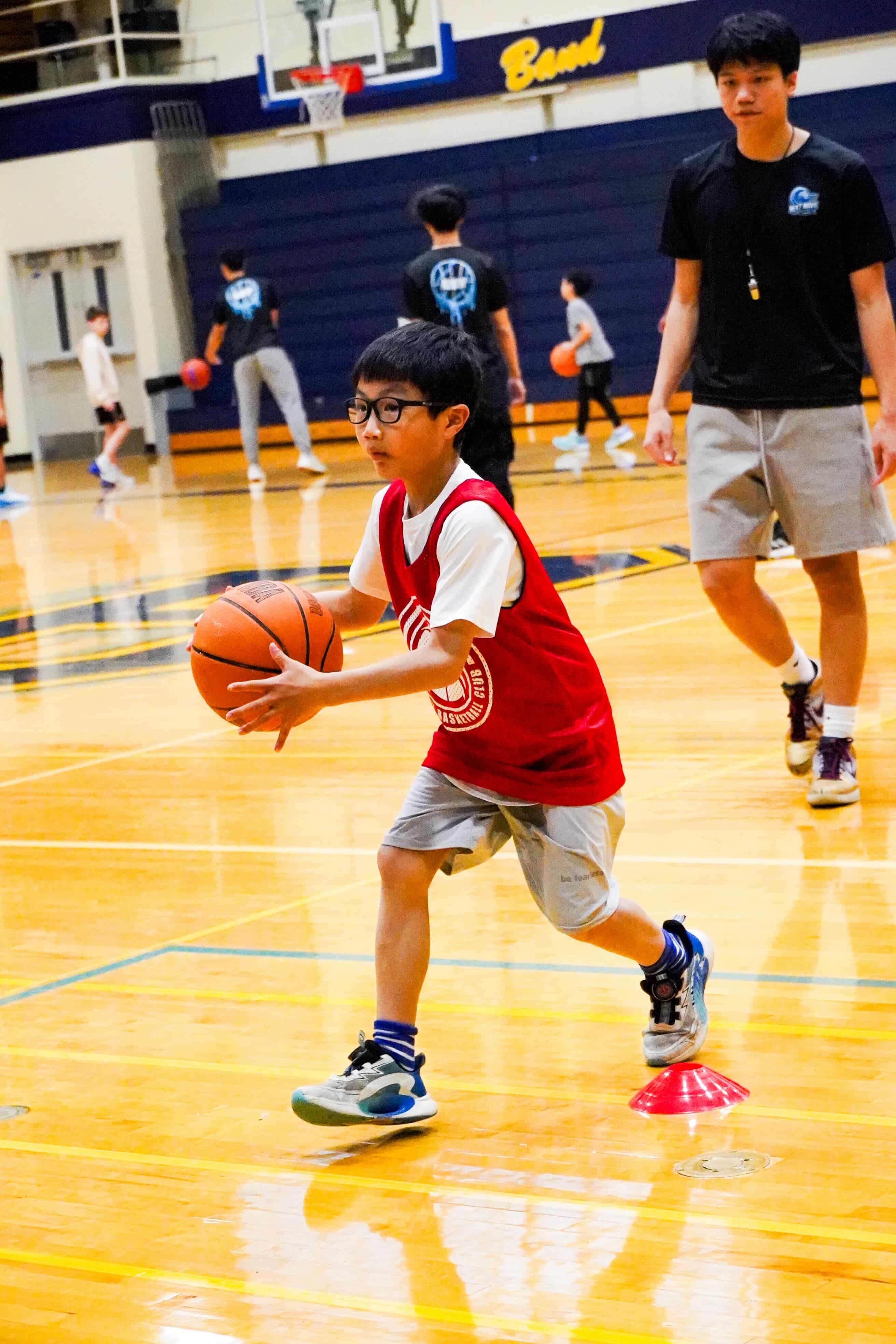 Player dribbling through cones at indoor practice
