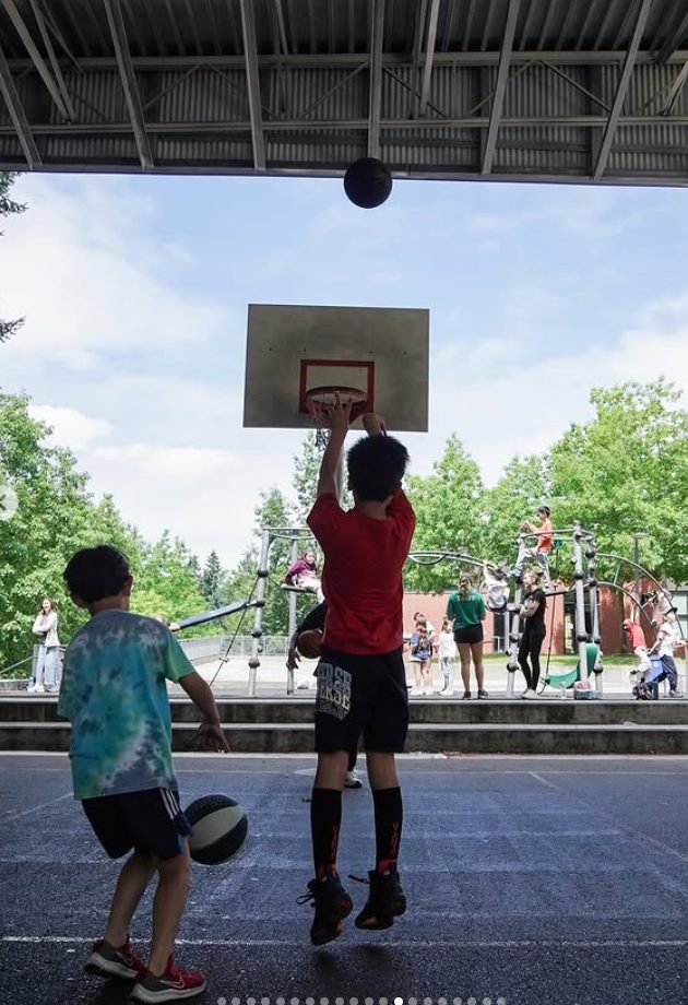 Young players shooting at an outdoor court